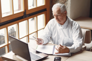 man sitting at a desk on a computer